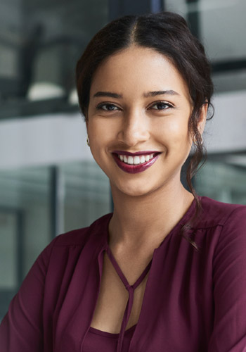 Woman smiles knowing Trustmark Voluntary Benefits offers her employees better protection and improves retention, productivity and cost containment